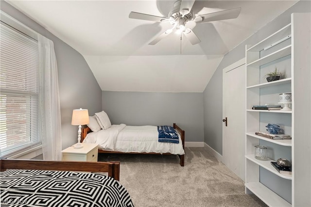 bedroom with carpet floors, a ceiling fan, baseboards, and lofted ceiling