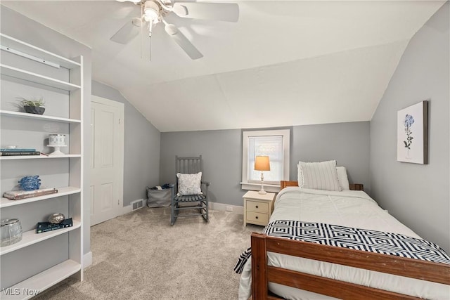 bedroom featuring ceiling fan, visible vents, baseboards, lofted ceiling, and carpet flooring