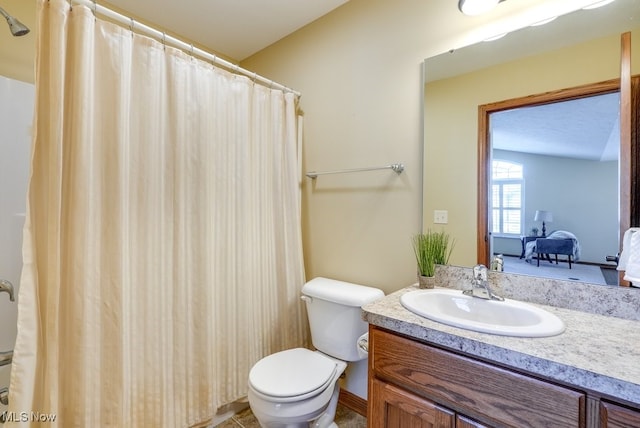 full bathroom with vanity, ensuite bathroom, and toilet