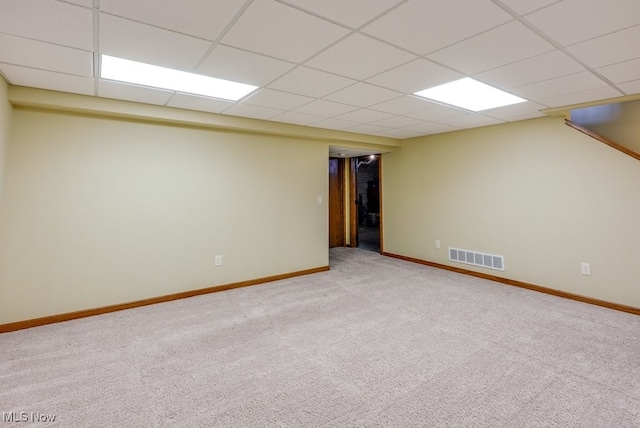 interior space featuring baseboards, visible vents, and a drop ceiling