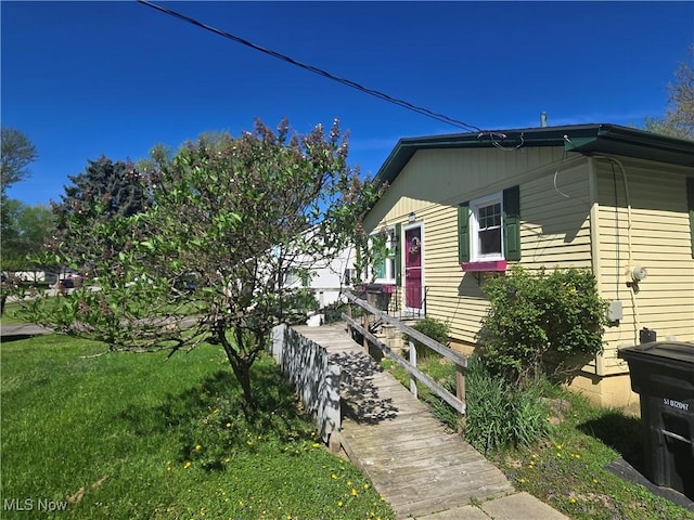 view of side of property with a yard