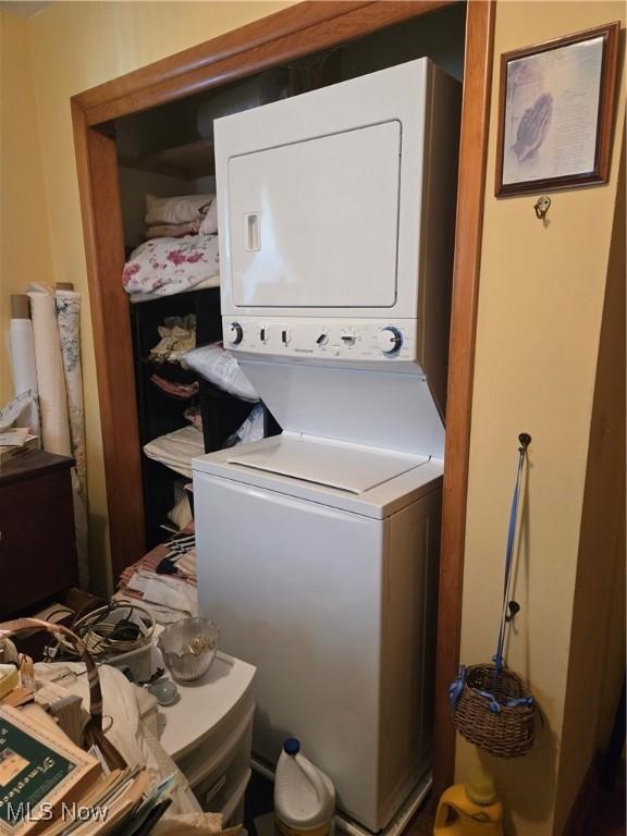 laundry room featuring laundry area and stacked washer / dryer