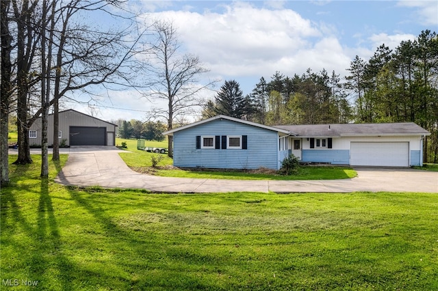 view of front facade with a garage, an outdoor structure, and a front lawn
