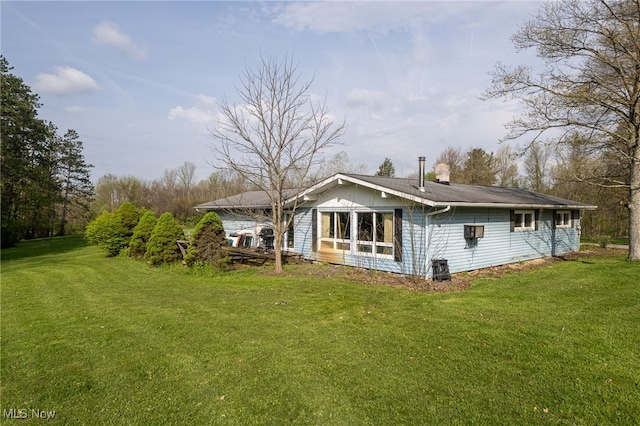 back of property with a yard