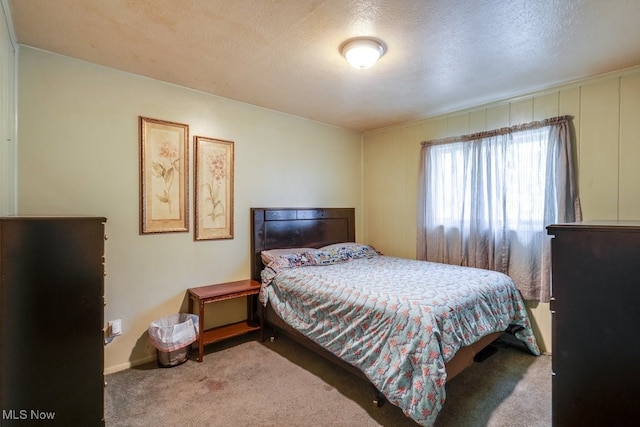 carpeted bedroom with a textured ceiling