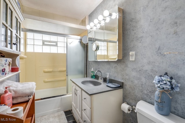 bathroom with vanity, enclosed tub / shower combo, tile patterned flooring, and toilet
