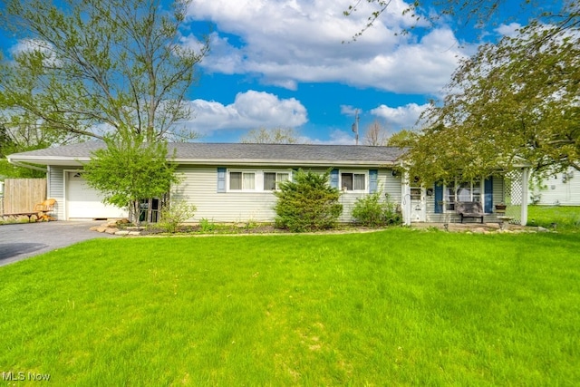 single story home with a garage, fence, a front lawn, and aphalt driveway