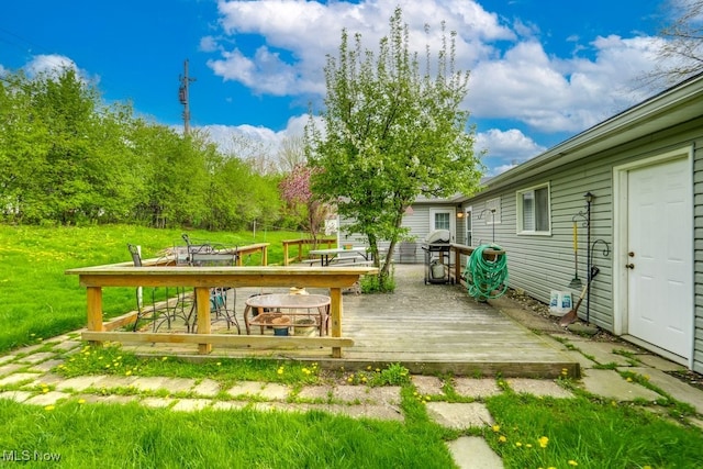 wooden deck featuring outdoor dining area and grilling area