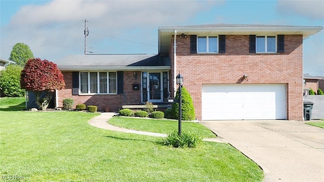 tri-level home with brick siding, a garage, a front lawn, and driveway