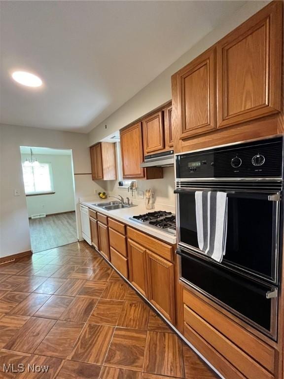 kitchen with brown cabinetry, stainless steel gas cooktop, a warming drawer, oven, and dishwasher