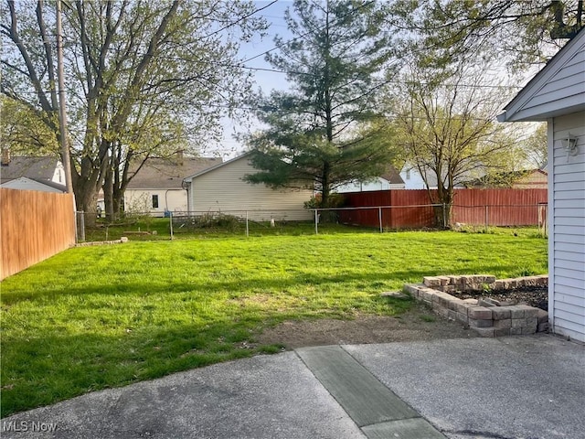 view of yard with fence and a patio