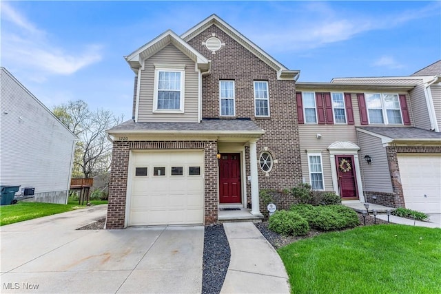 view of front of house with a front lawn, brick siding, central AC unit, an attached garage, and driveway