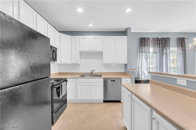 kitchen featuring a sink, tasteful backsplash, black appliances, and white cabinetry