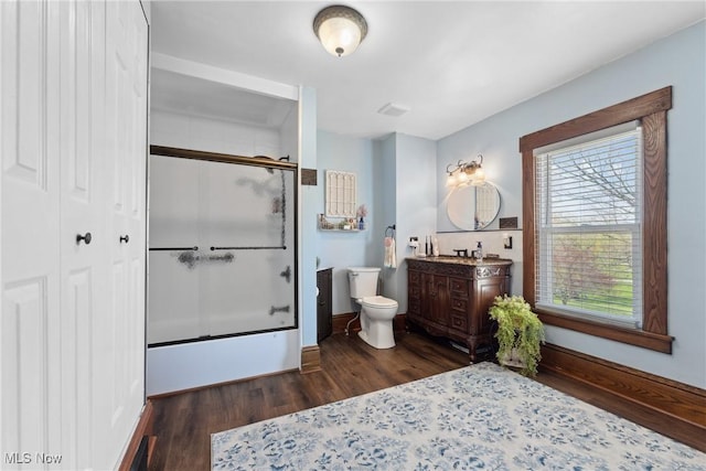 full bath with vanity, baseboards, wood finished floors, and toilet