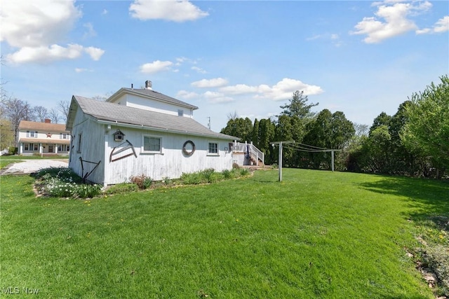 rear view of property with a yard