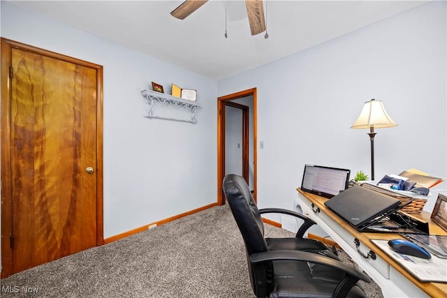 carpeted office featuring baseboards and ceiling fan