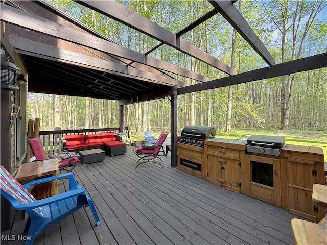 wooden deck with an outdoor kitchen, a pergola, an outdoor hangout area, and a grill