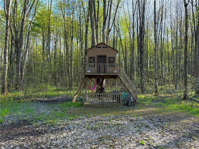 view of jungle gym featuring an outbuilding and stairs