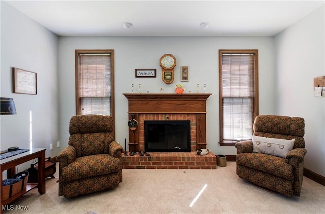 sitting room with carpet flooring and a fireplace