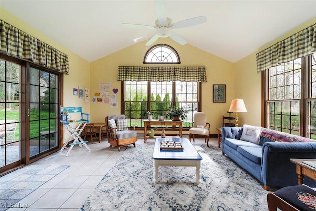 tiled living area with a ceiling fan and lofted ceiling