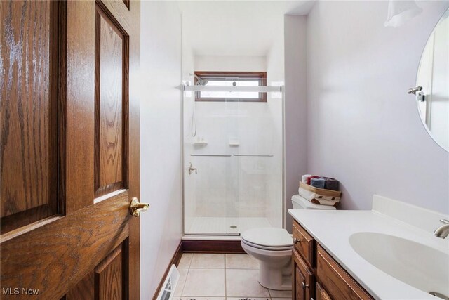 bathroom featuring vanity, tile patterned floors, a shower stall, and toilet