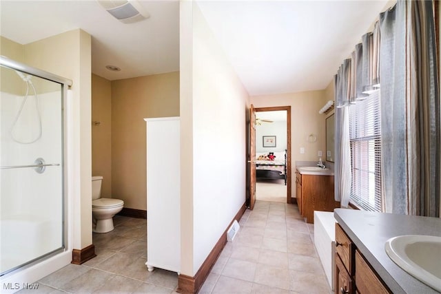 ensuite bathroom featuring vanity, toilet, tile patterned floors, ensuite bathroom, and a stall shower