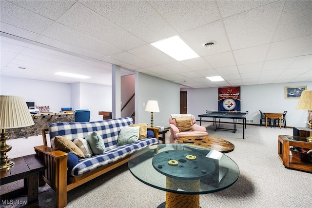 carpeted living room featuring visible vents and a drop ceiling