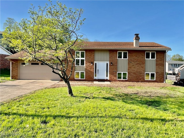 bi-level home featuring an attached garage, board and batten siding, a front yard, a chimney, and concrete driveway