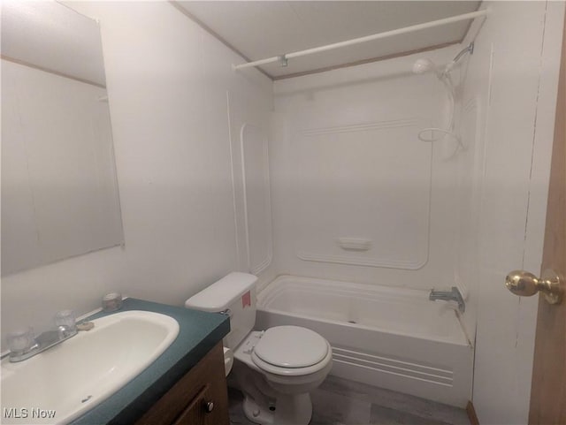 bathroom featuring toilet, shower / washtub combination, and vanity