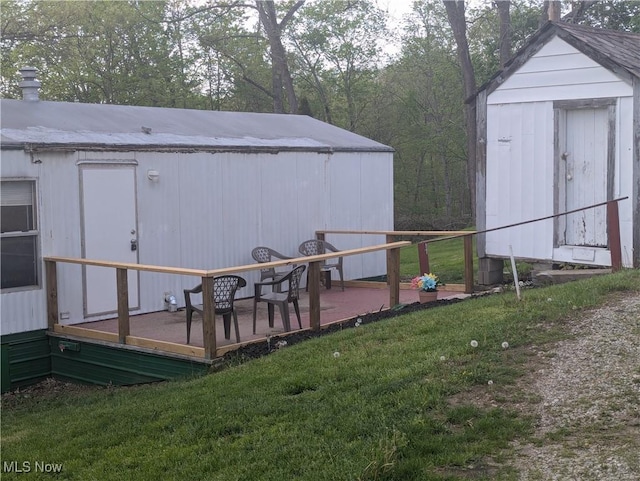 exterior space with a storage shed and an outbuilding