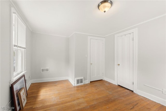unfurnished bedroom with baseboards, visible vents, and light wood-style floors
