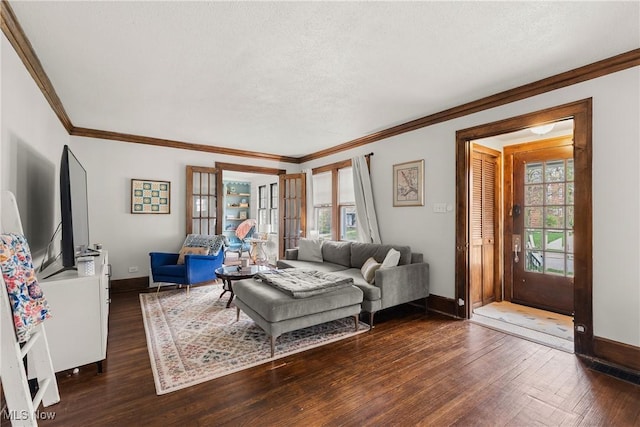 living room featuring baseboards, ornamental molding, and a wealth of natural light