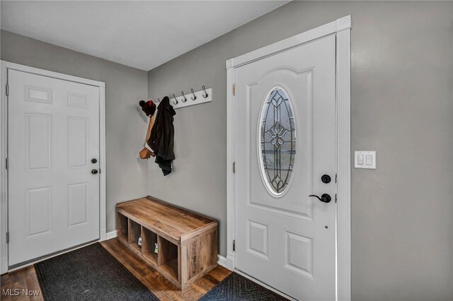 entryway featuring baseboards and dark wood finished floors