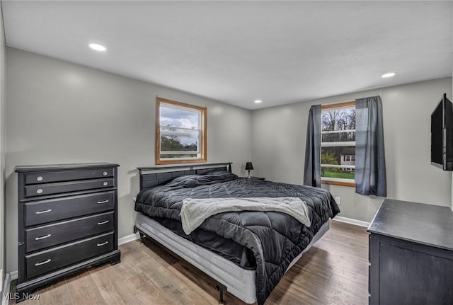 bedroom with baseboards, recessed lighting, and wood finished floors