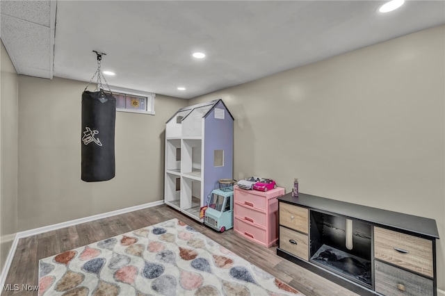 rec room with recessed lighting, baseboards, and wood finished floors