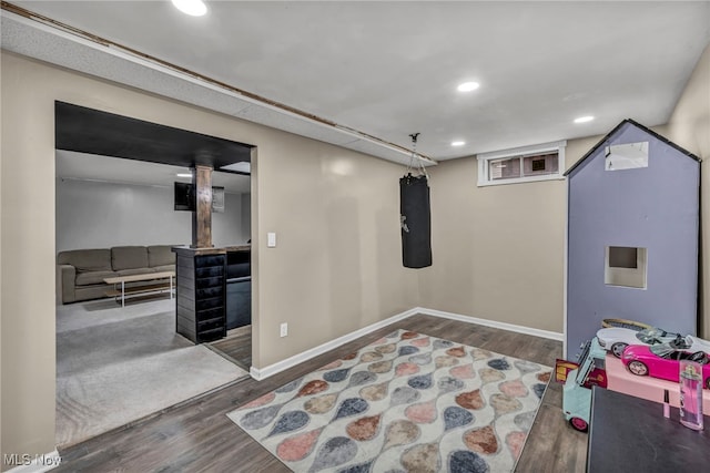 basement with recessed lighting, baseboards, and wood finished floors