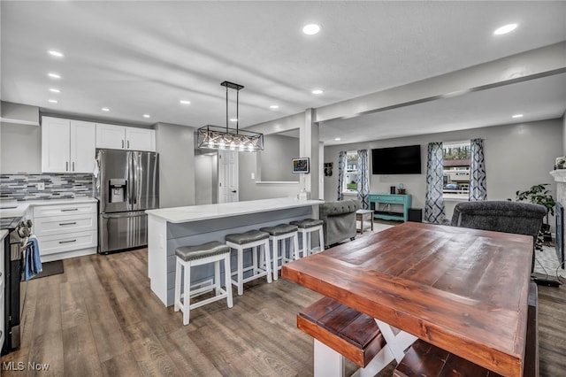 dining room featuring recessed lighting and dark wood-type flooring