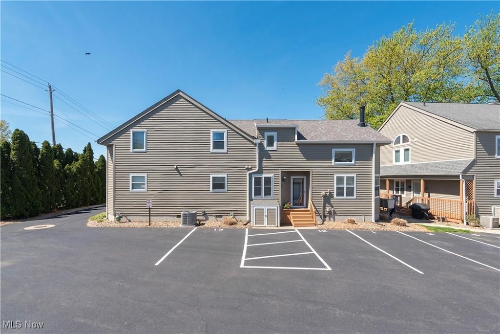 13011 W Lake Rd Unit 12C, Vermilion, OH 44089 - view of property featuring uncovered parking and central air condition unit