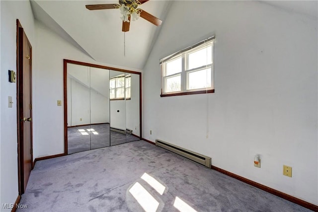 spare room featuring carpet flooring, baseboards, ceiling fan, a baseboard radiator, and vaulted ceiling