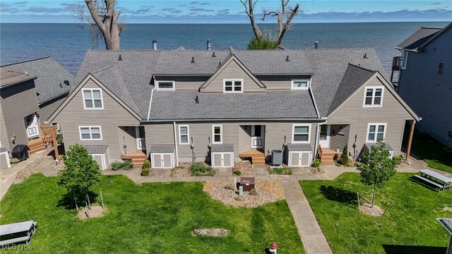 13011 W Lake Rd Unit 3A, Vermilion, OH 44089 - rear view of house with a lawn, a water view, and roof with shingles