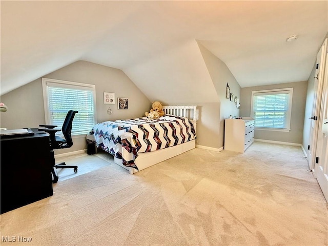 bedroom with carpet floors, baseboards, and lofted ceiling