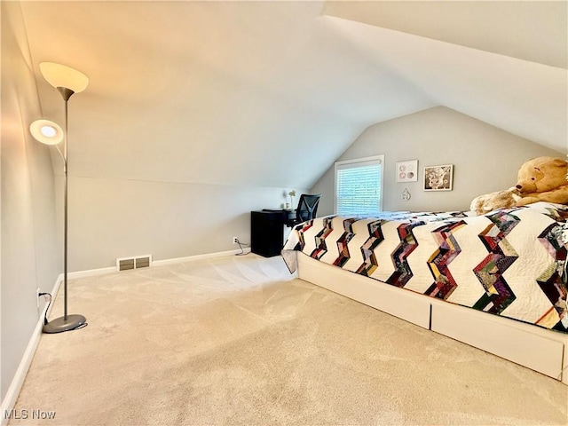 bedroom with baseboards, carpet, lofted ceiling, and visible vents