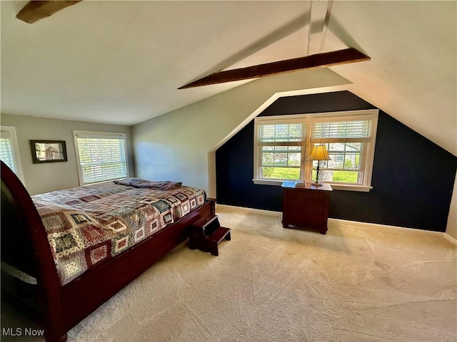 bedroom with carpet floors and lofted ceiling with beams