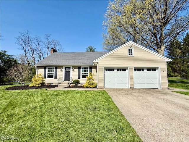 view of front of home with a garage, a front lawn, driveway, and a chimney