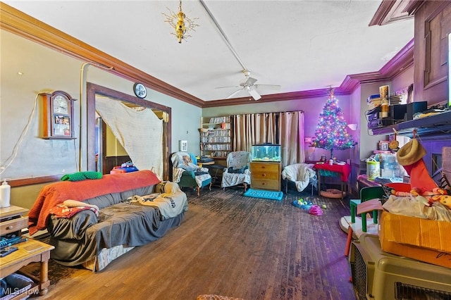 interior space featuring ornamental molding, a ceiling fan, and wood finished floors