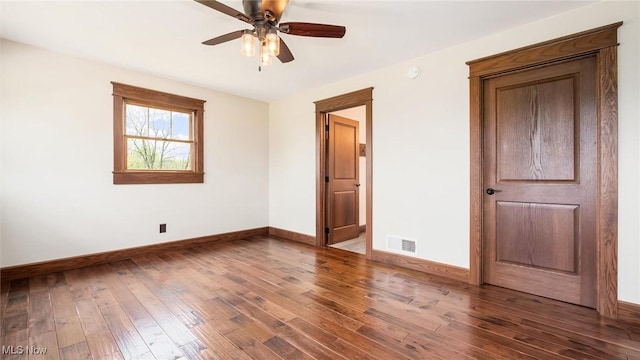 unfurnished bedroom featuring visible vents, a ceiling fan, baseboards, and wood-type flooring