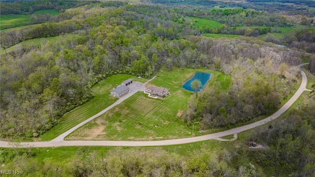 birds eye view of property featuring a water view and a forest view