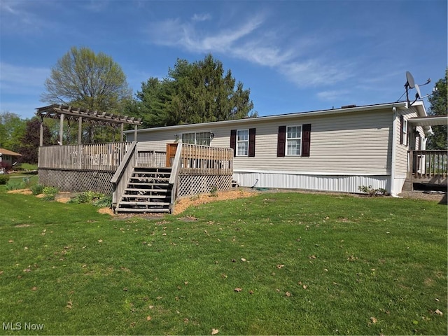 back of property with a lawn, a pergola, stairway, and a wooden deck