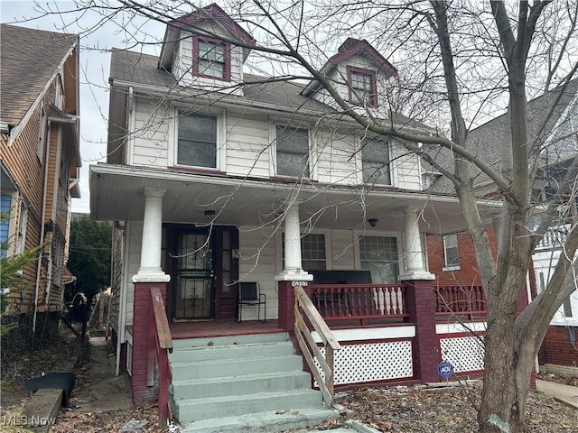 townhome / multi-family property with covered porch and roof with shingles