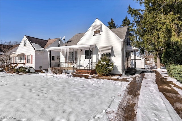 bungalow featuring a porch and driveway